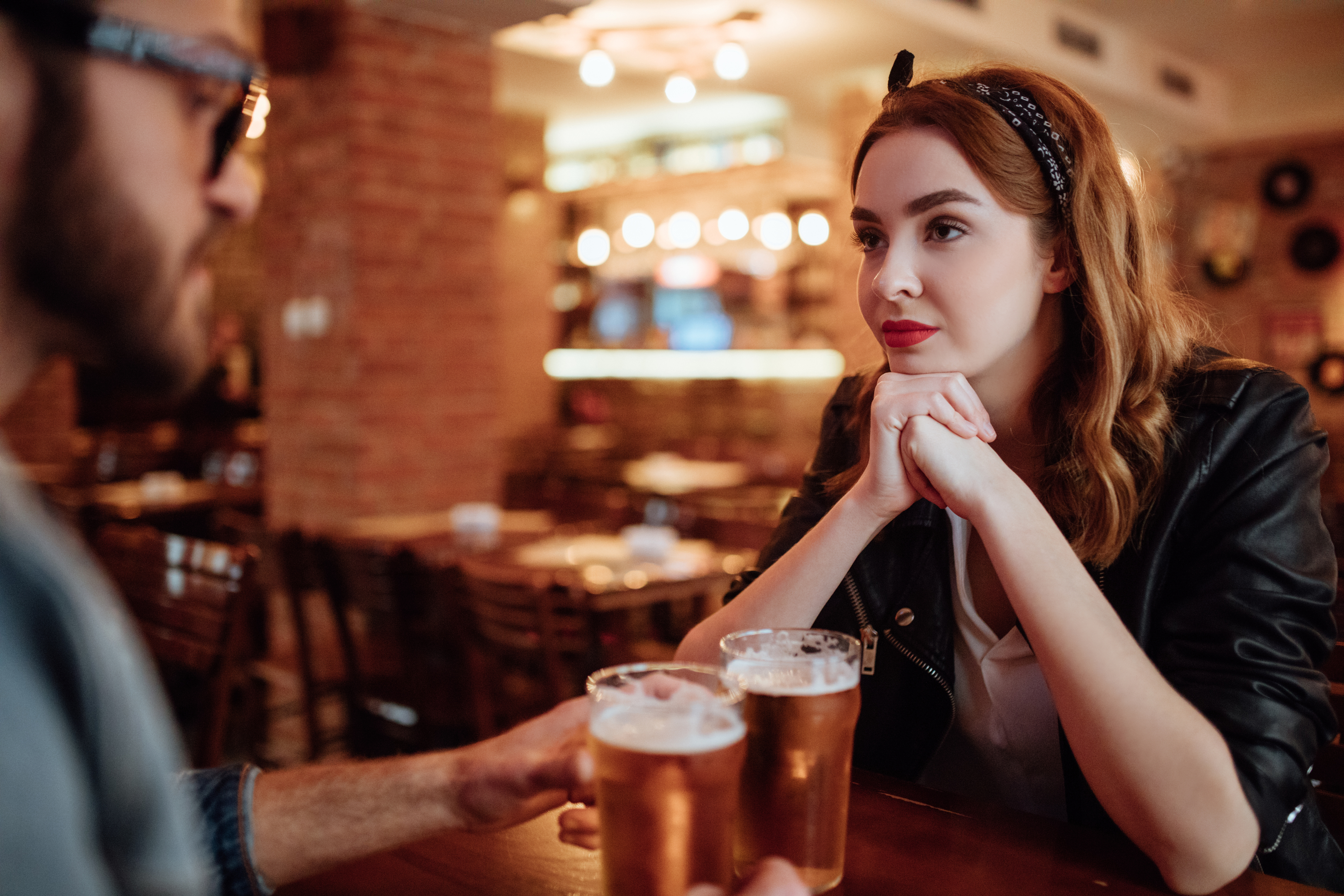 a man and woman talking over drinks