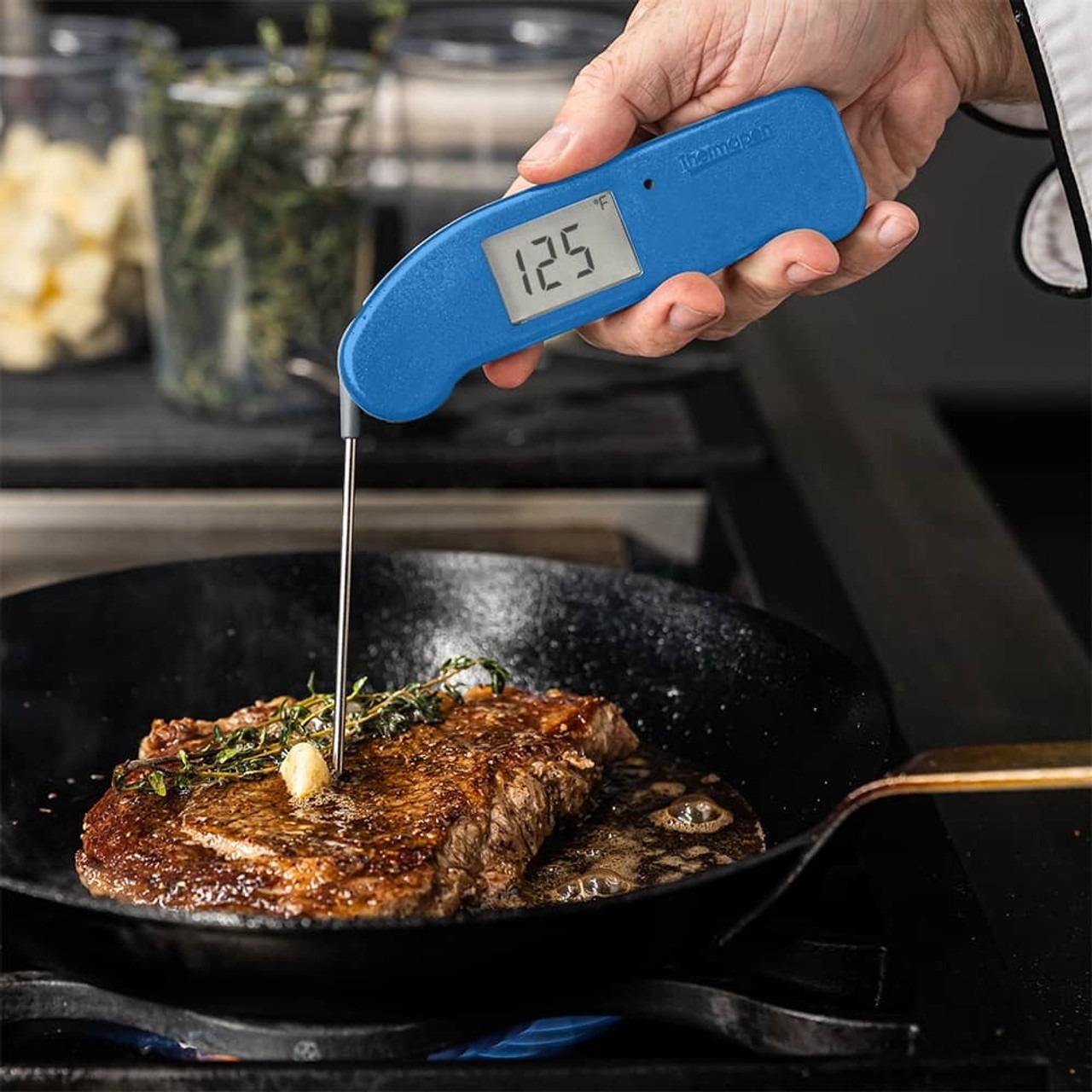 model inserting blue Thermapen into steak