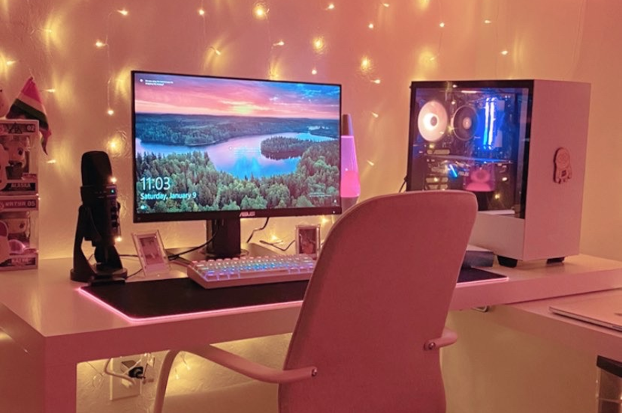the fairy lights strung behind a pink desk setup