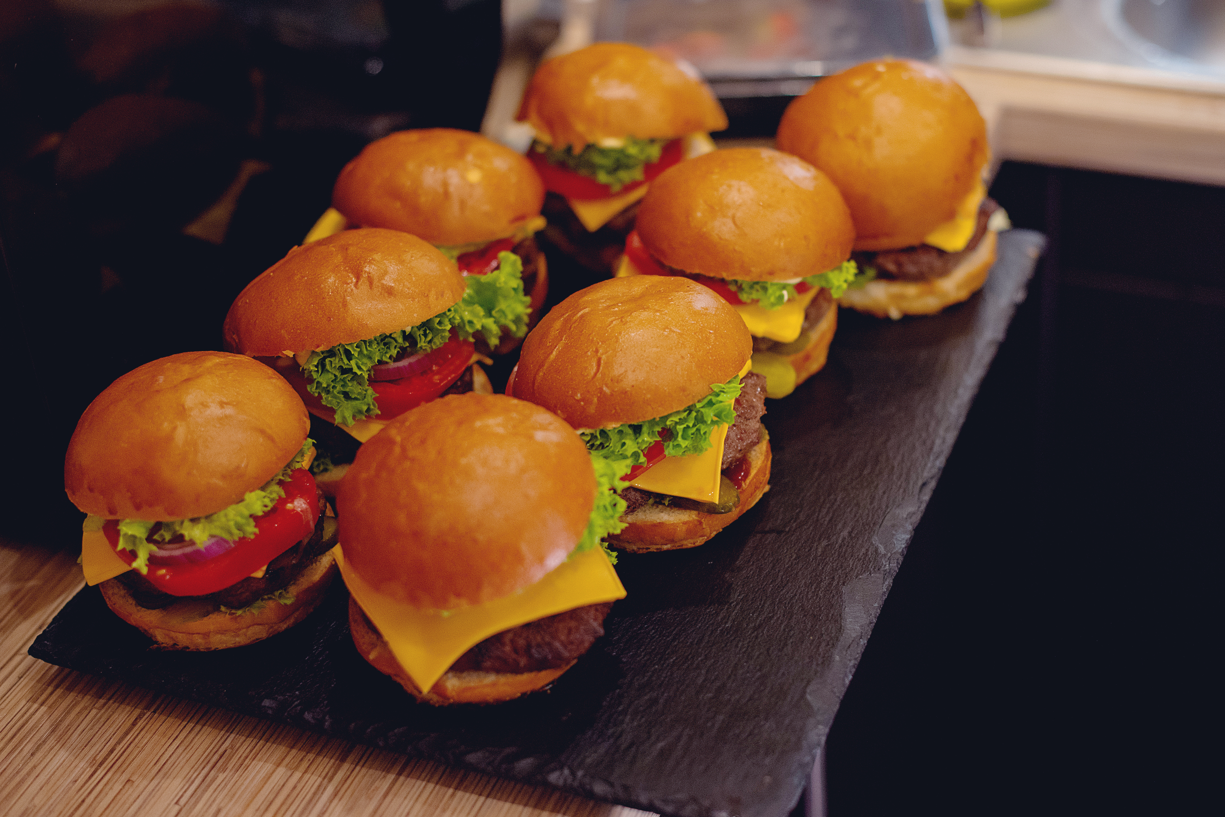 Two rows of cheeseburgers on a tray