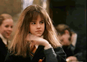 Hermione Granger waves her hand in front of her face as if something smells.