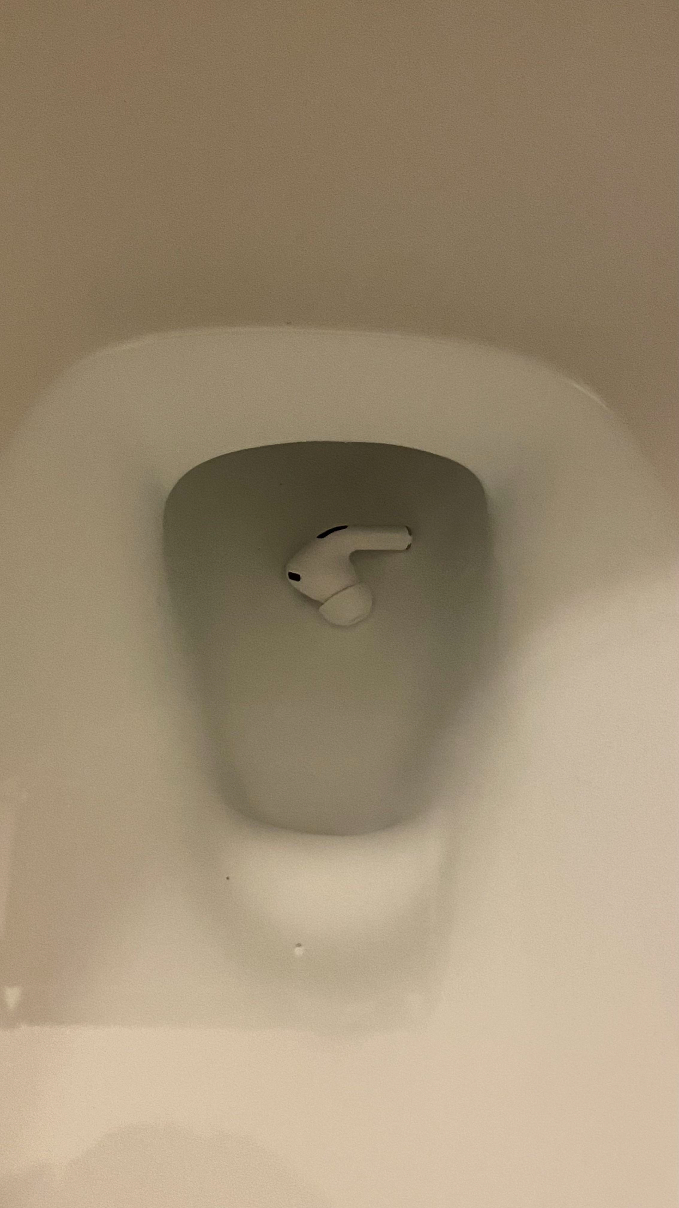 An AirPod in a toilet