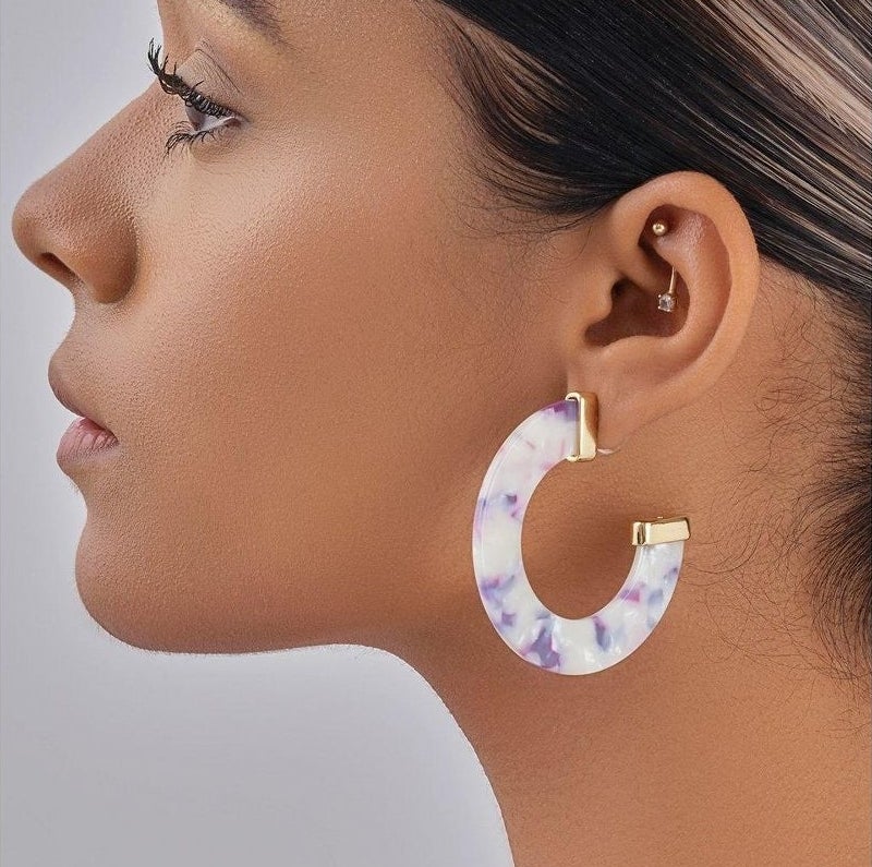 a model wearing the earrings