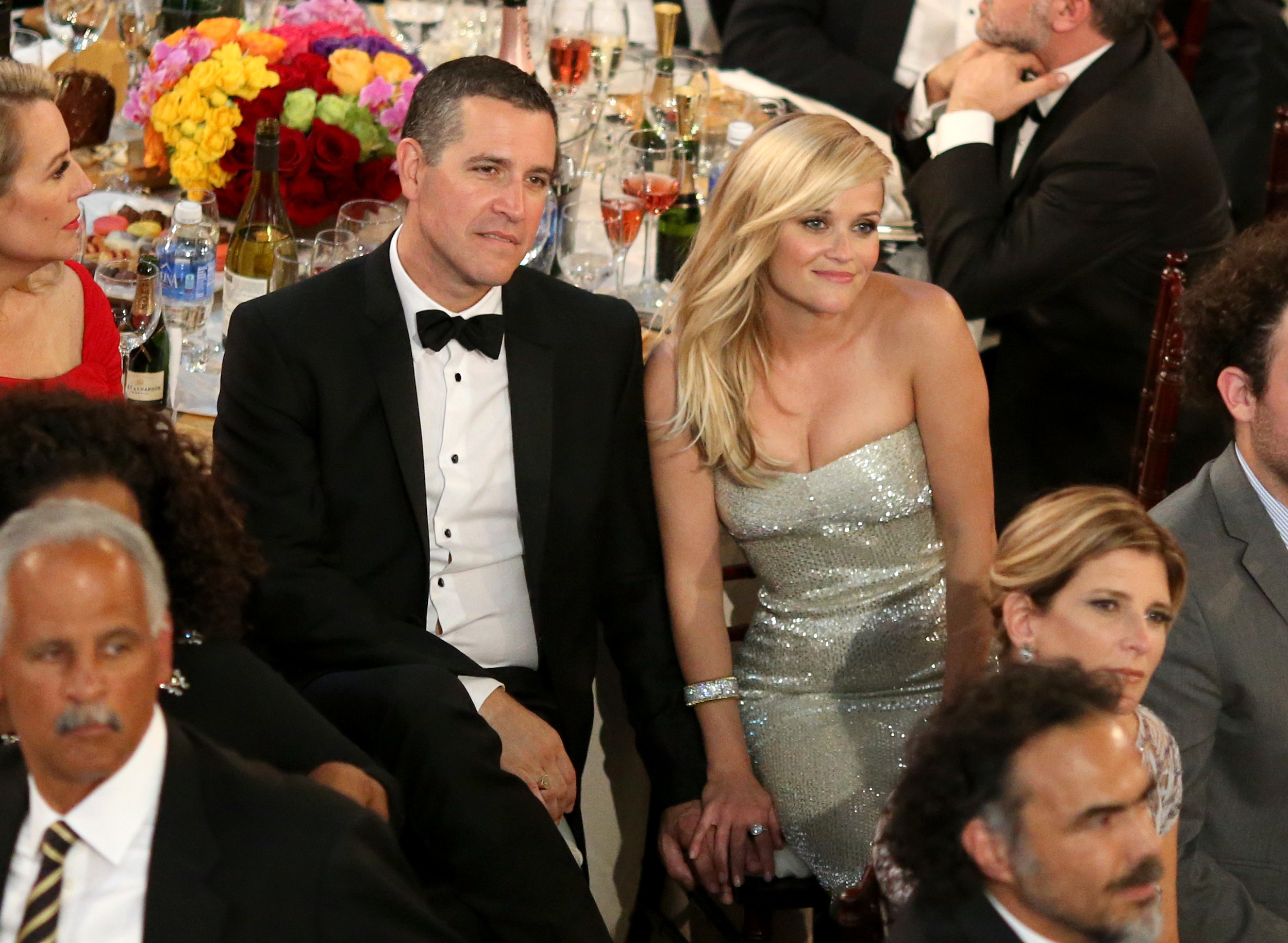 Close-up of Reese and Jim smiling at a table at a gala event