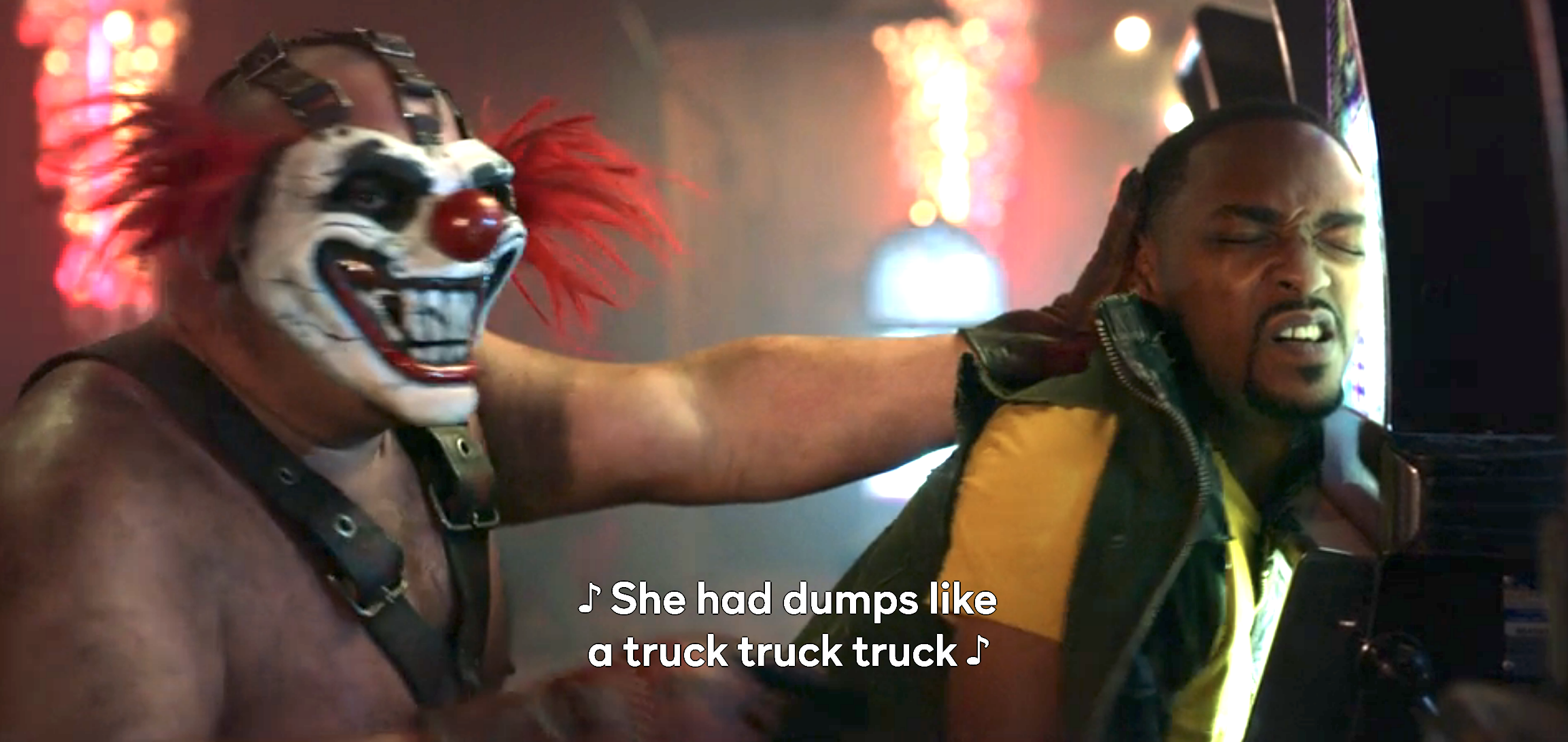 A bare-chested clown standing behind a man with the caption &quot;She had dumps like a truck, truck, truck&quot;
