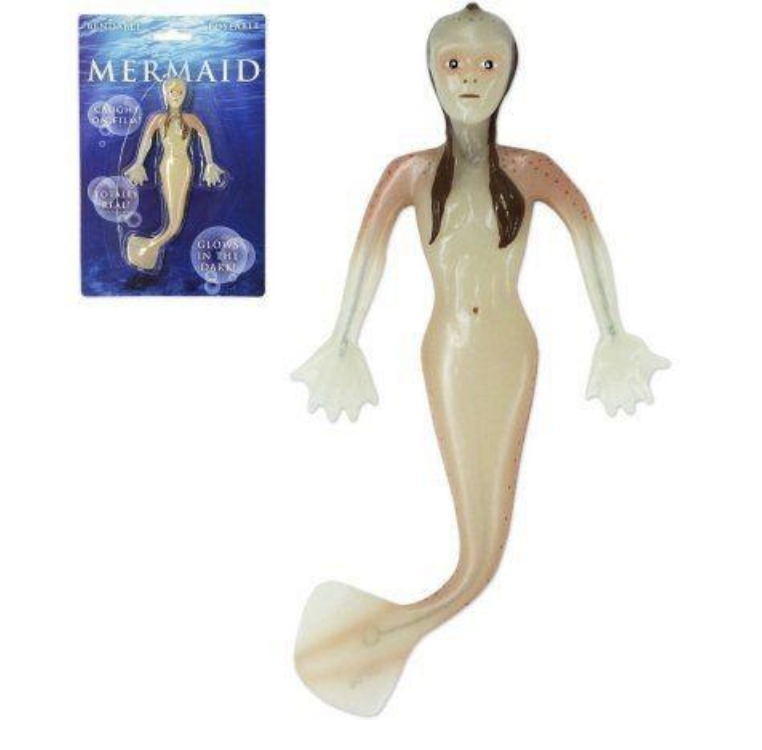 A creepy mermaid night-light with a skull face, hollowed-out eyes, and webbed hands