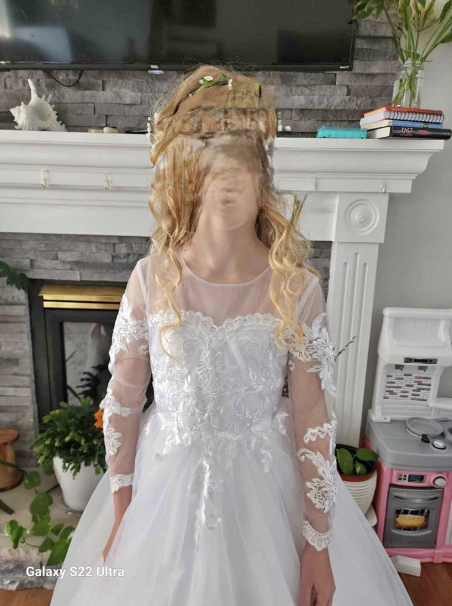 A person wearing a white dress with their face completely distorted