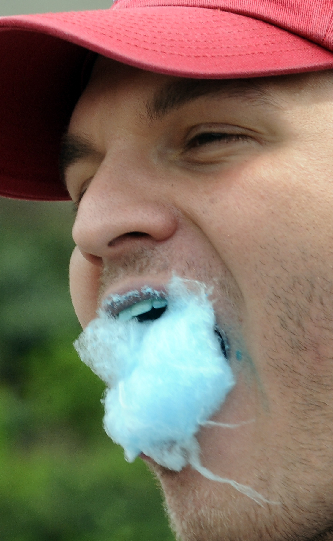 Close-up of a person eating cotton candy