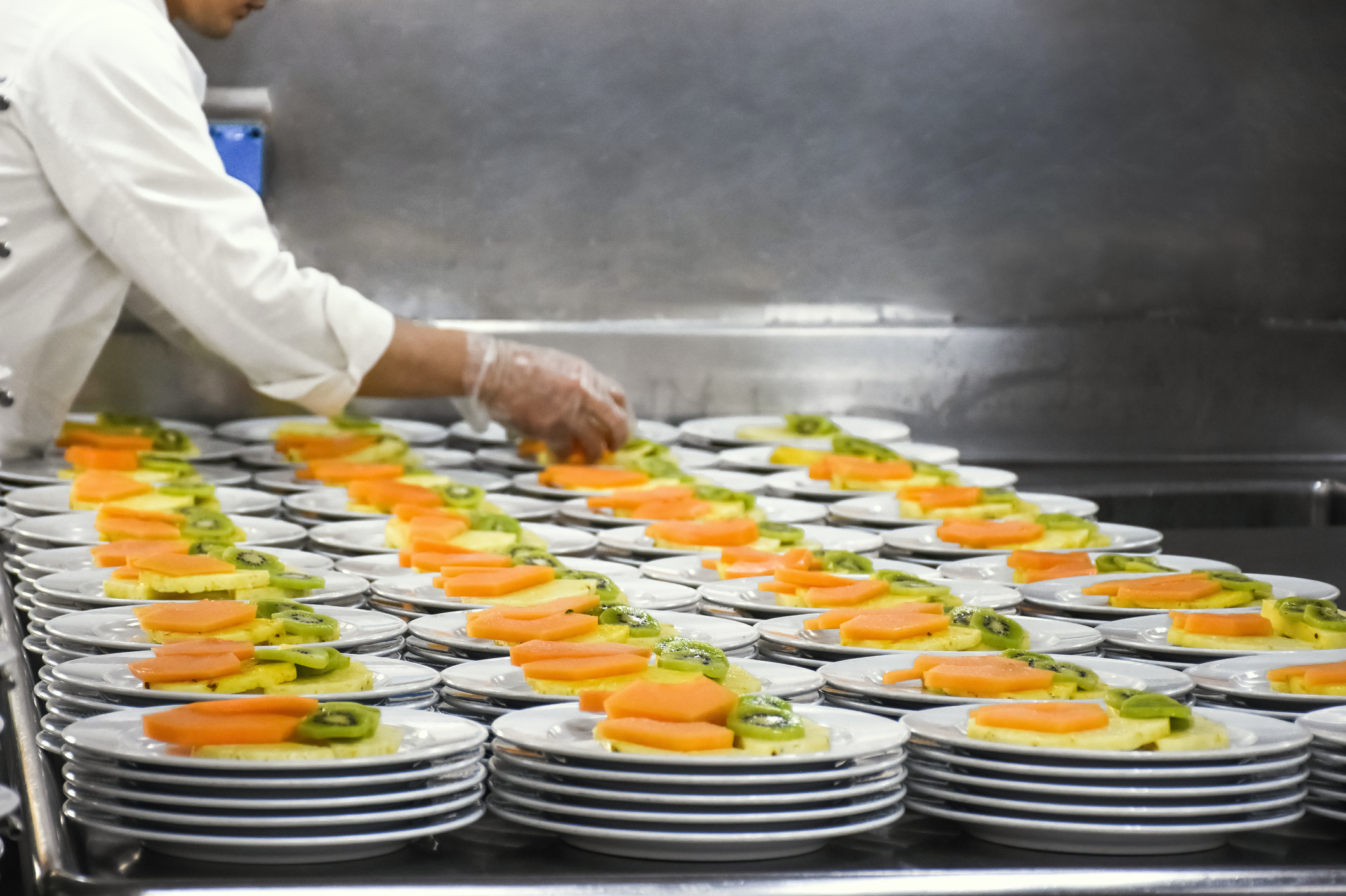 A chef is plating for catering