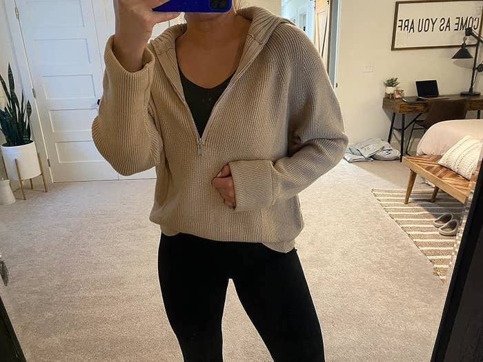 Reviewer wearing the cream sweater and black leggings