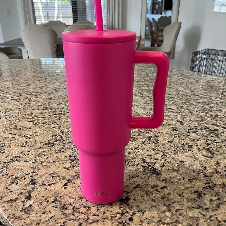 Reviewer image of the pink tumbler on their countertop