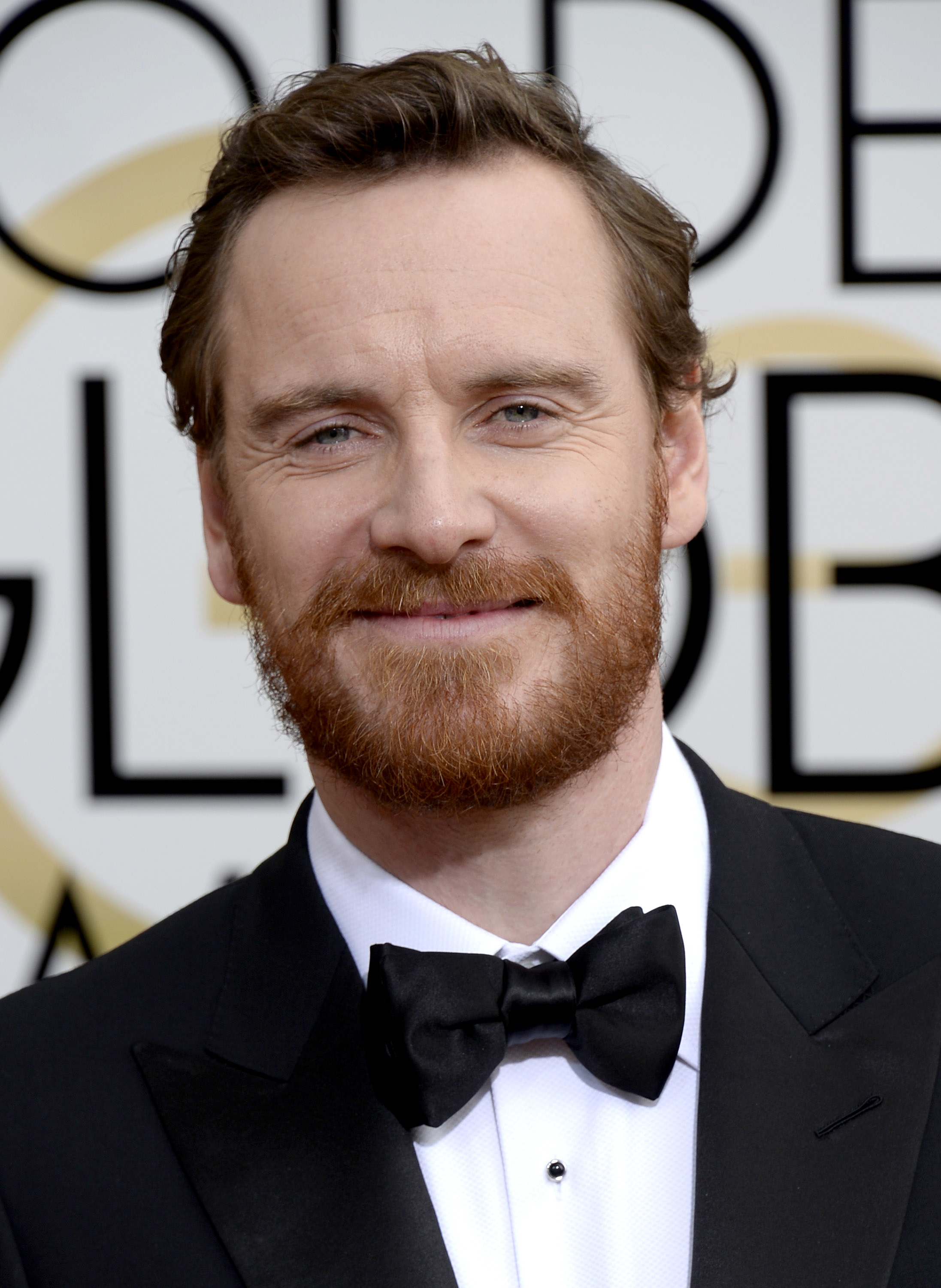 Closeup of Michael Fassbender on the red carpet in a tuxedo