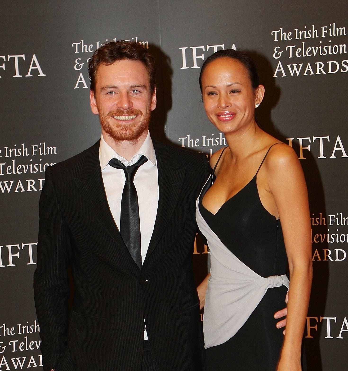 Michael Fassbender and Sunawin Andrews smile on the red carpet