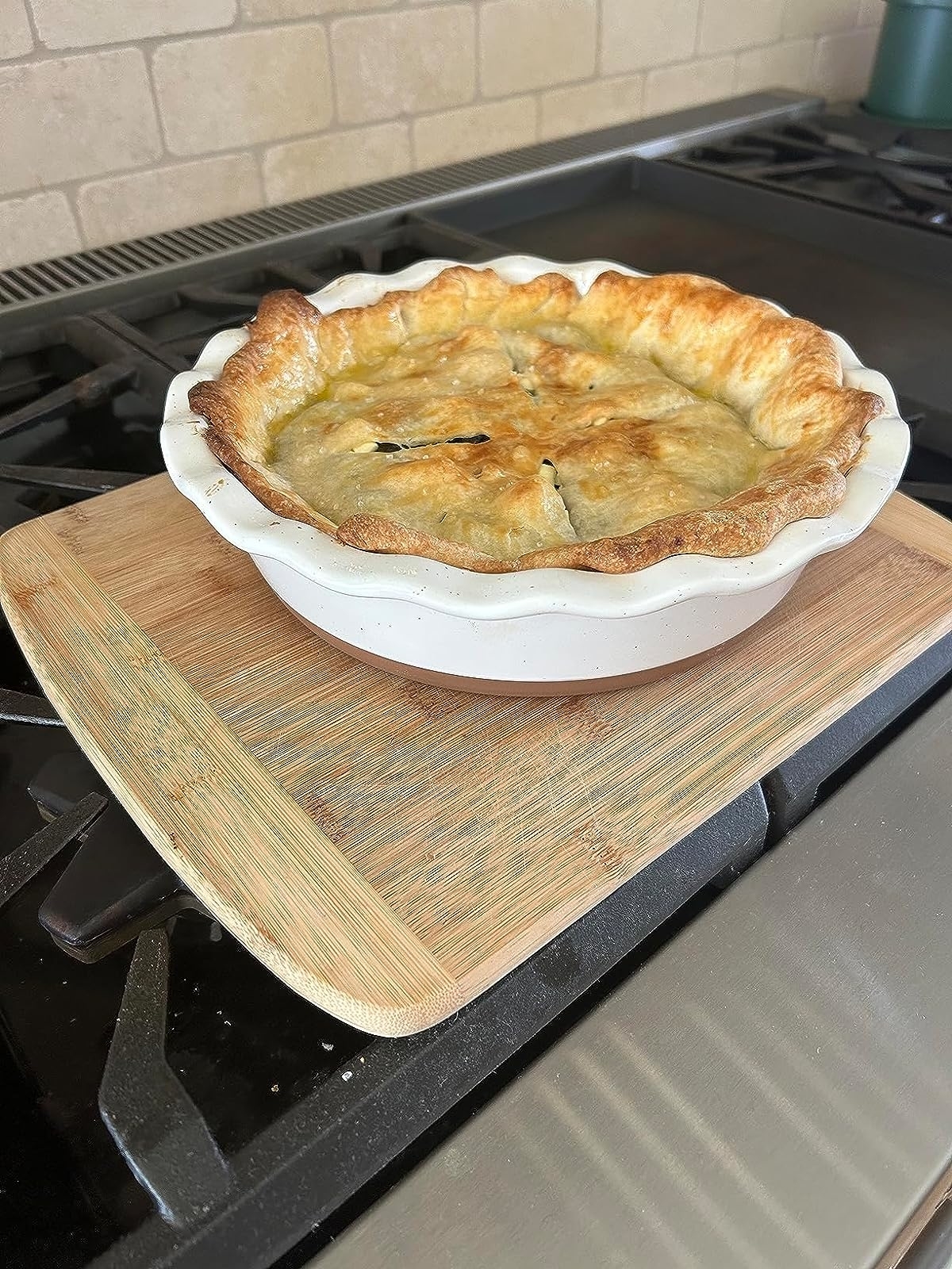 Reviewer image of a baked pie in the pie dish on a wooden chopping board