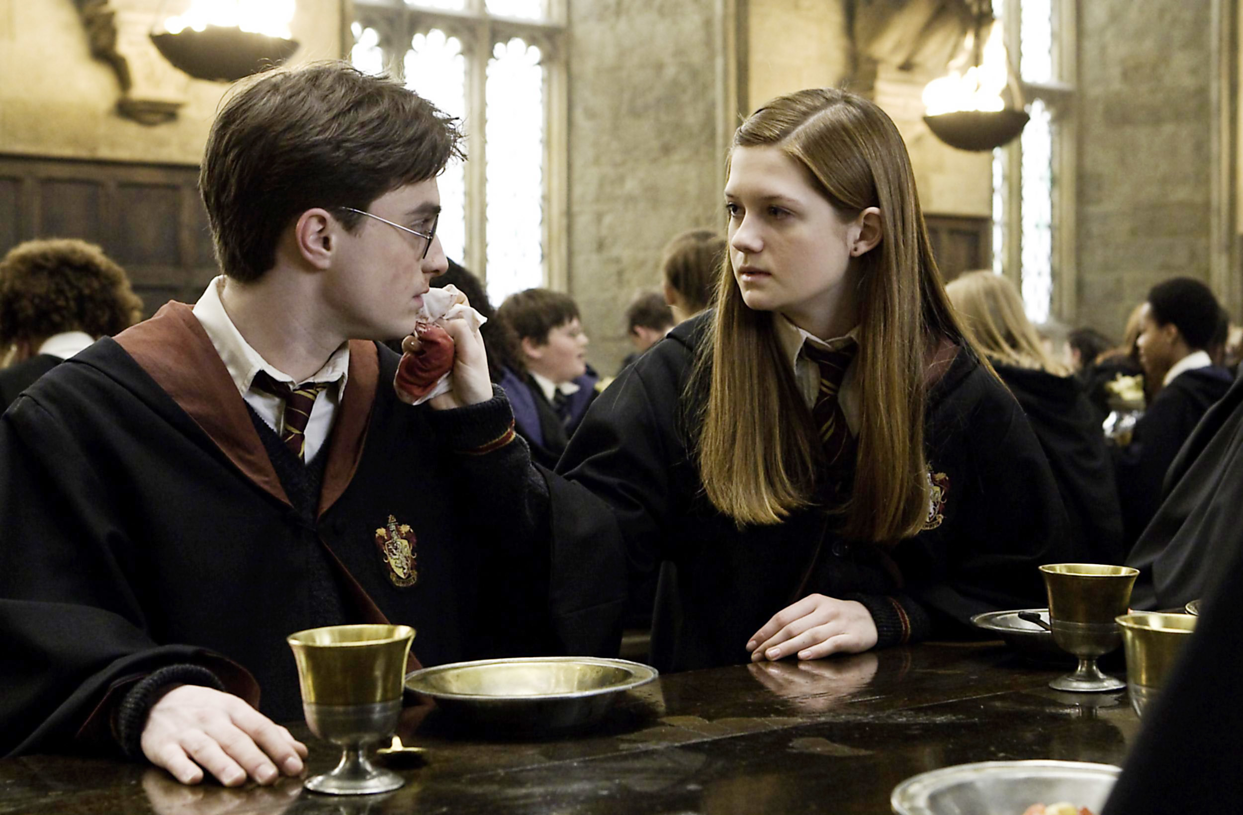 Ginny and Harry sitting in the Great Hall