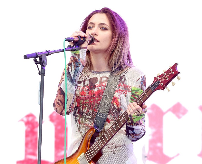 Paris Jackson onstage holding a guitar