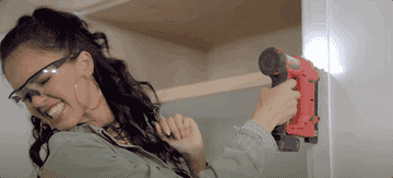 A gif of Jessica Alba using a nail gun