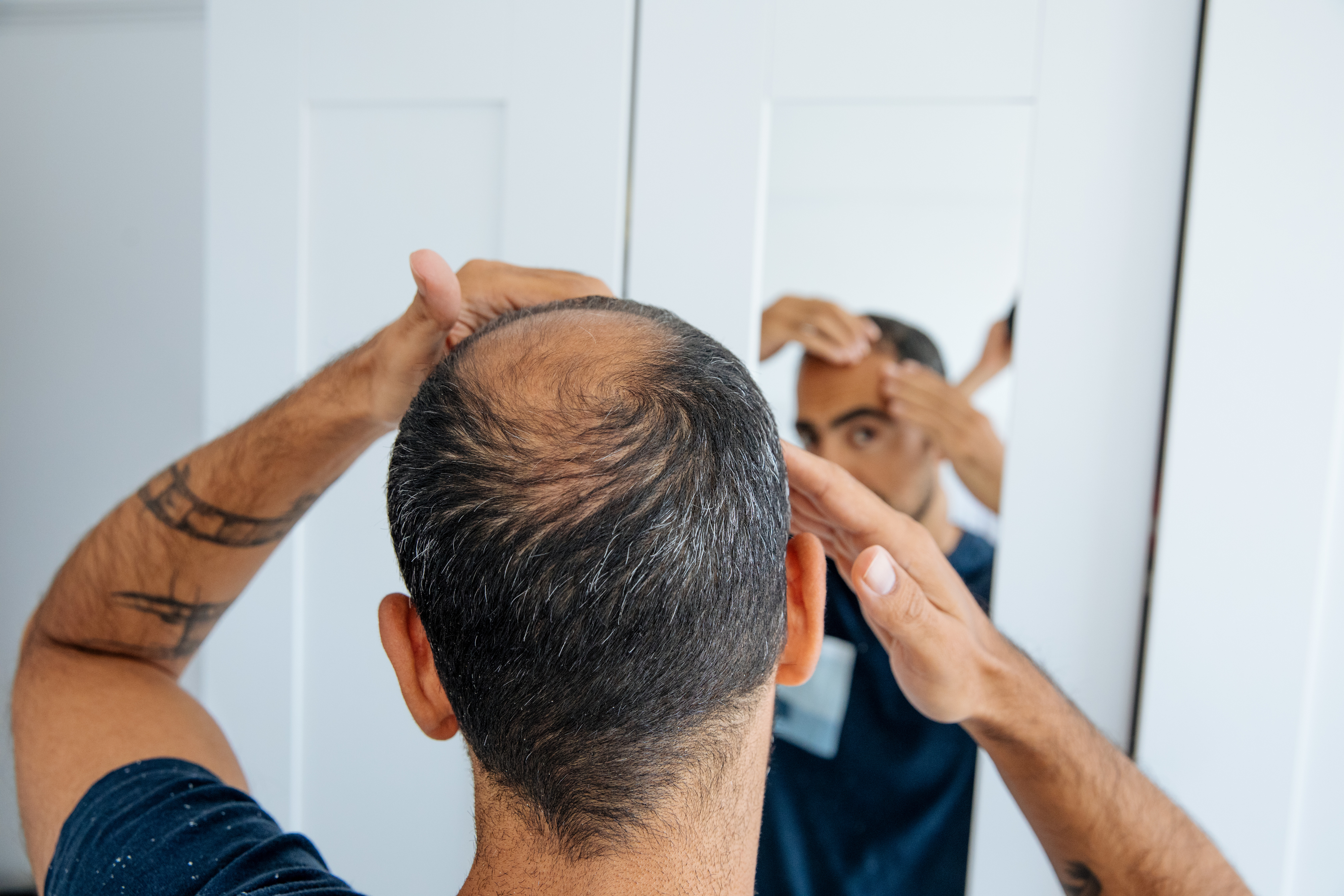 a man looking at himself in the mirror