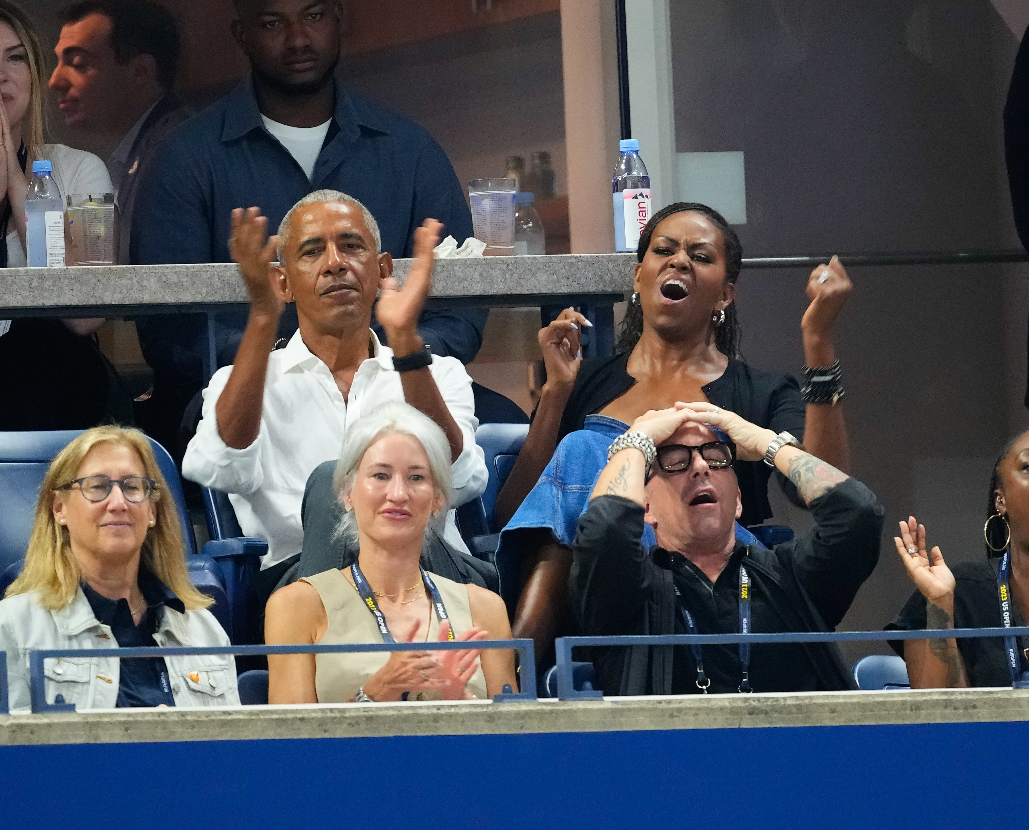 Barack and Michelle Obama cheering in the stands