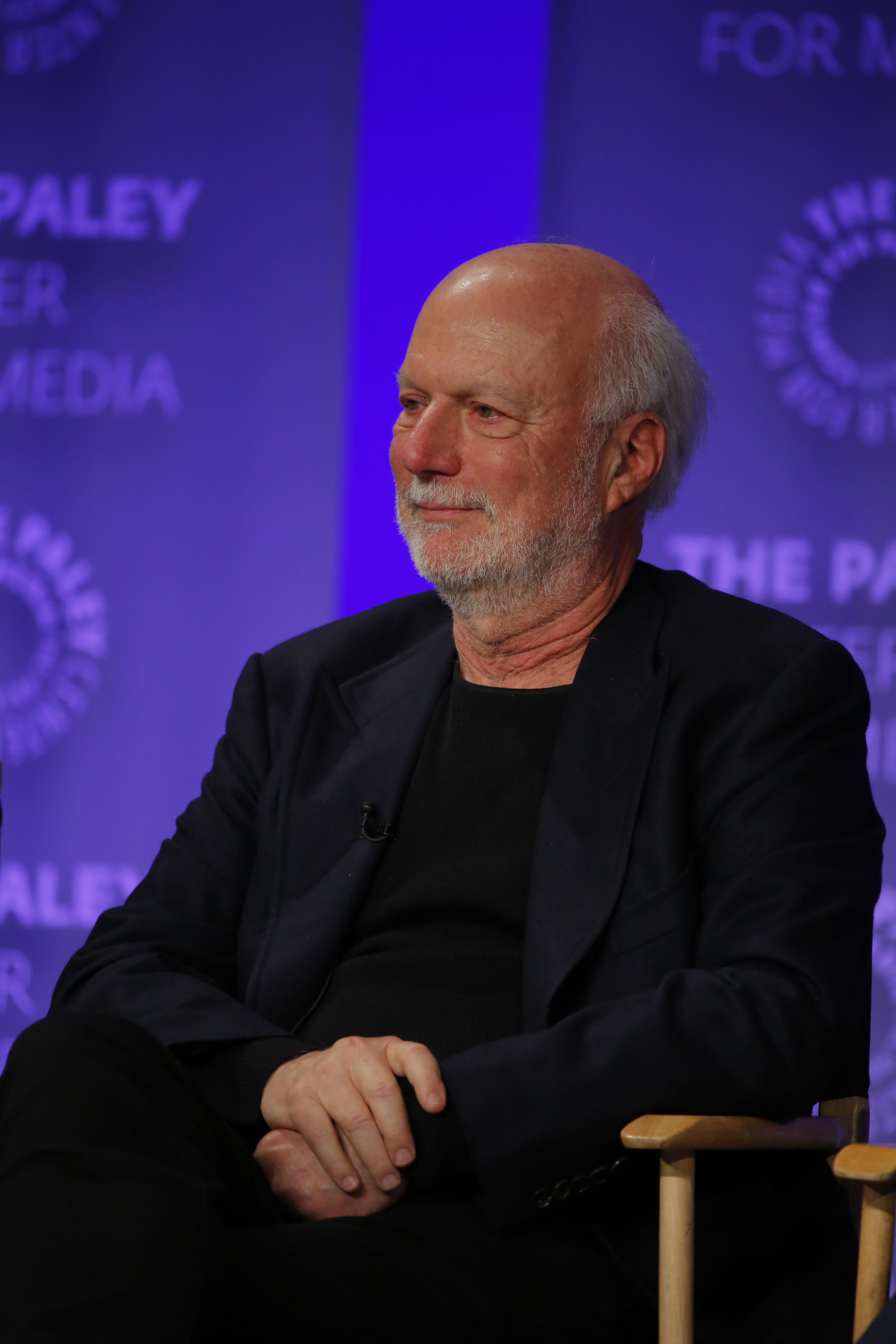 Close-up of James sitting at a media event