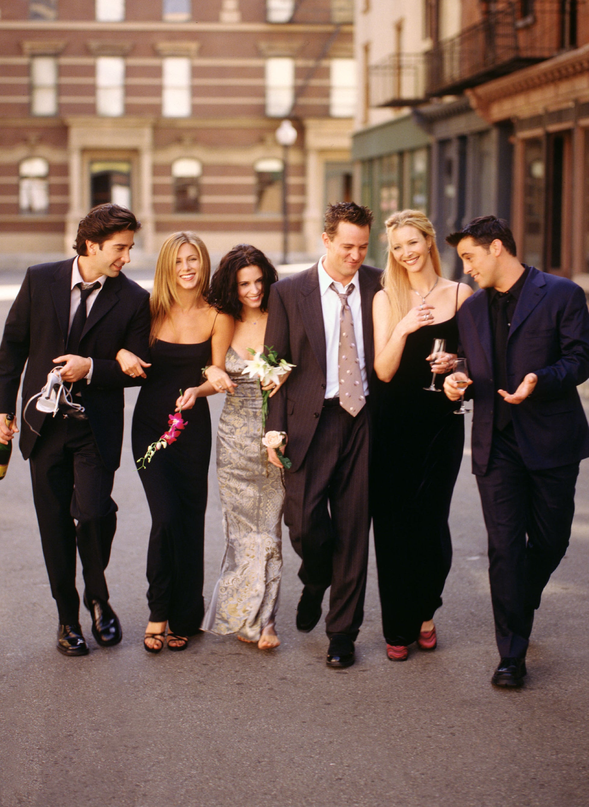 The costars in a scene walking together in the street