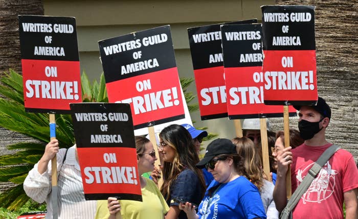 Writers on strike on a picket line with signs