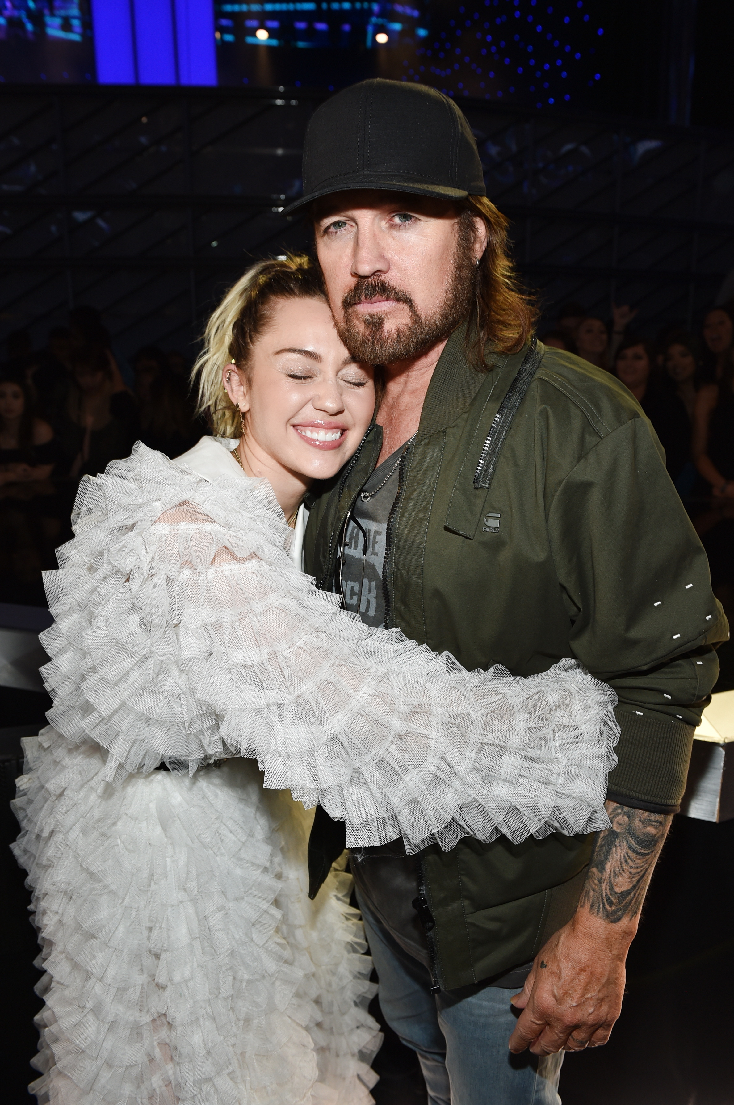 Closeup of Miley hugging Billy Ray