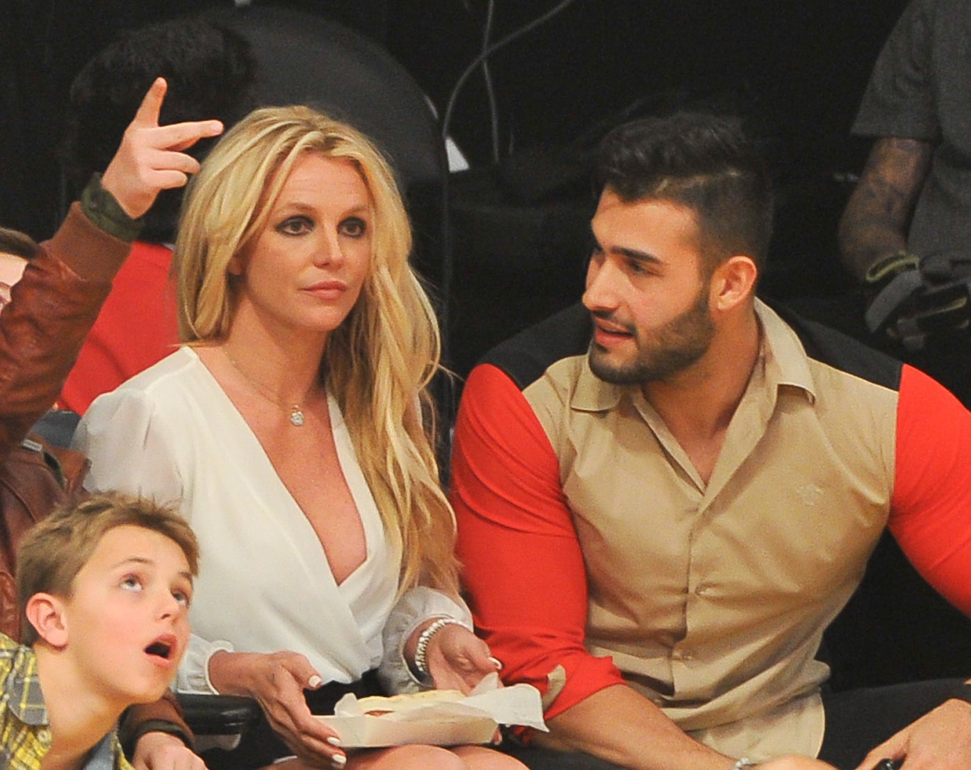 Close-up of Britney and Sam sitting together in an audience