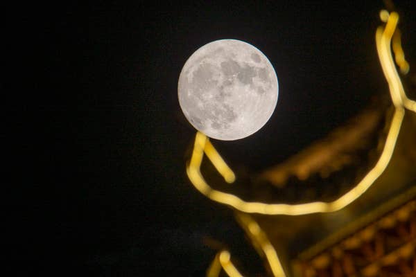 The supermoon is seen above Gulou Ecological Square in China's Guizhou province