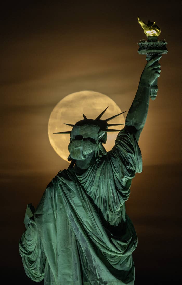 The Statue of Liberty in front of the moon