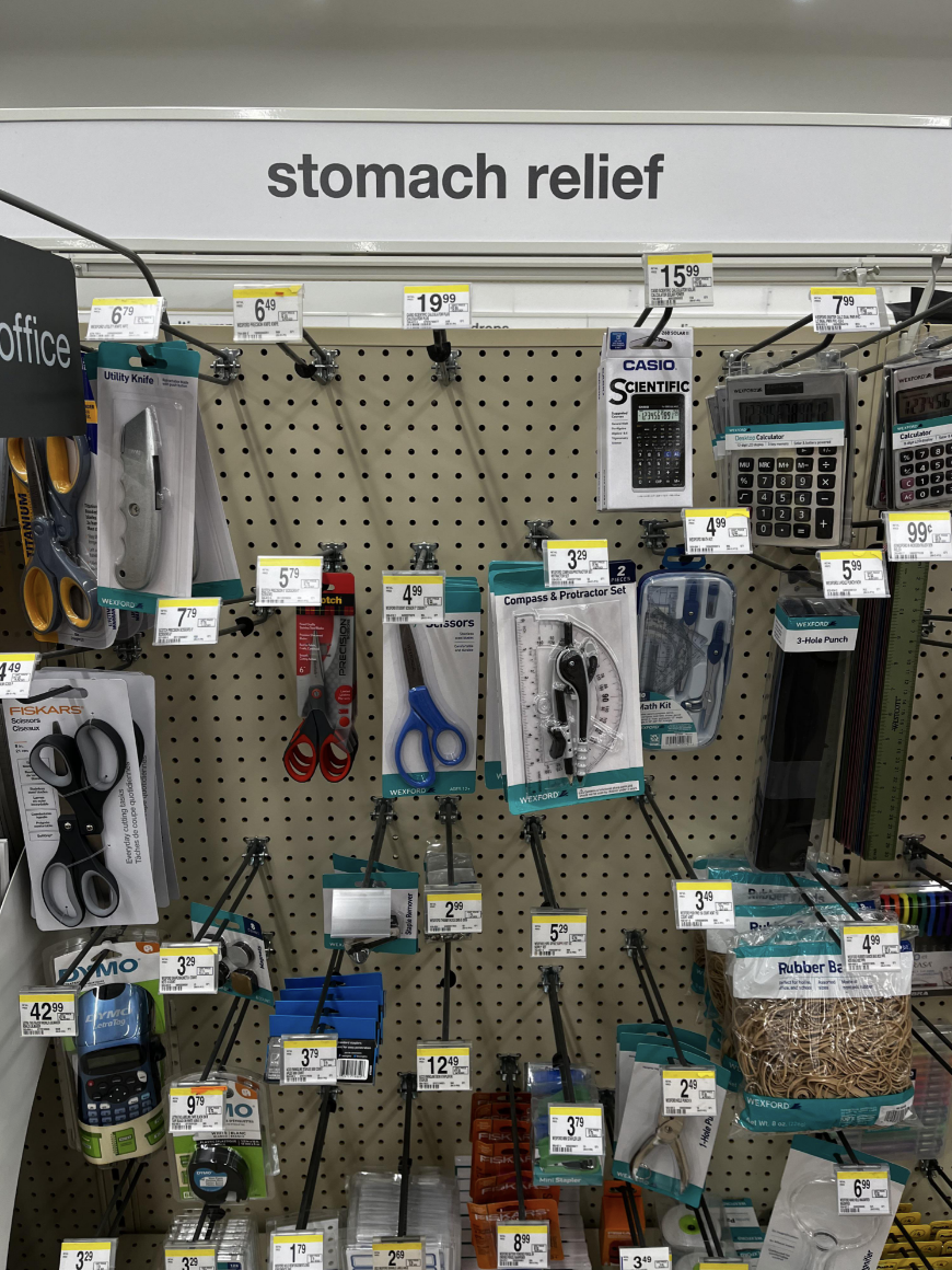 aisle for scissors and calculators labeled as stomach relief