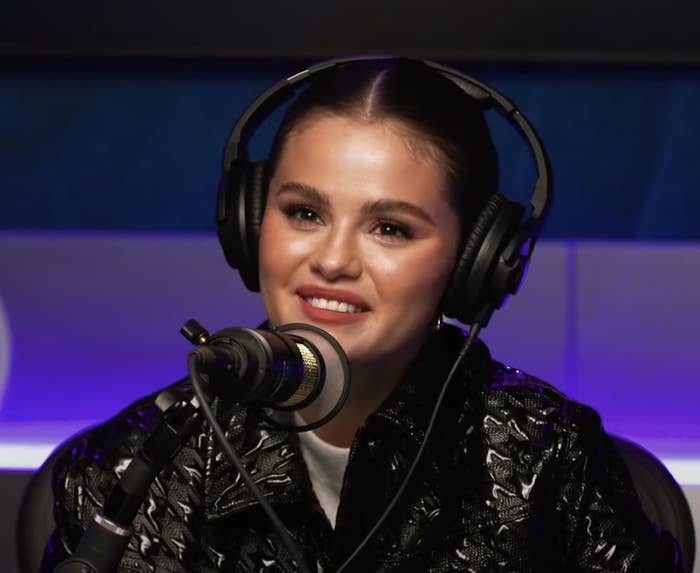 Closeup of Selena with headphones on during the interview