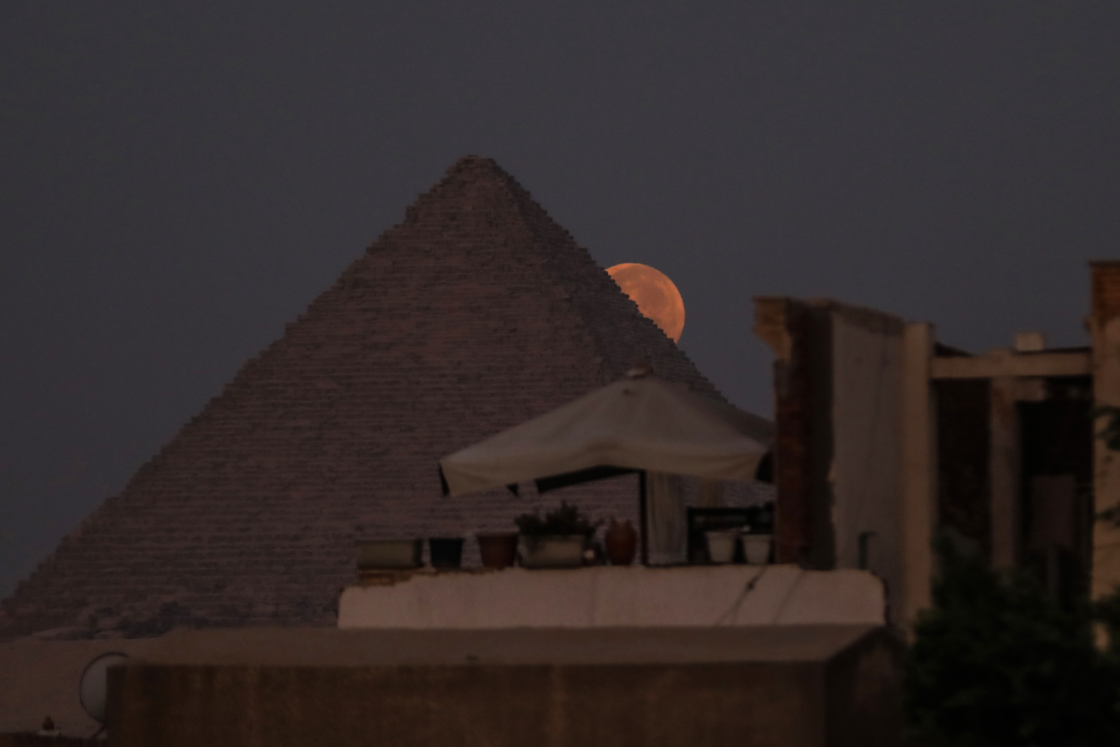 The blue supermoon is seen behind the Pyramids of Giza in Egypt