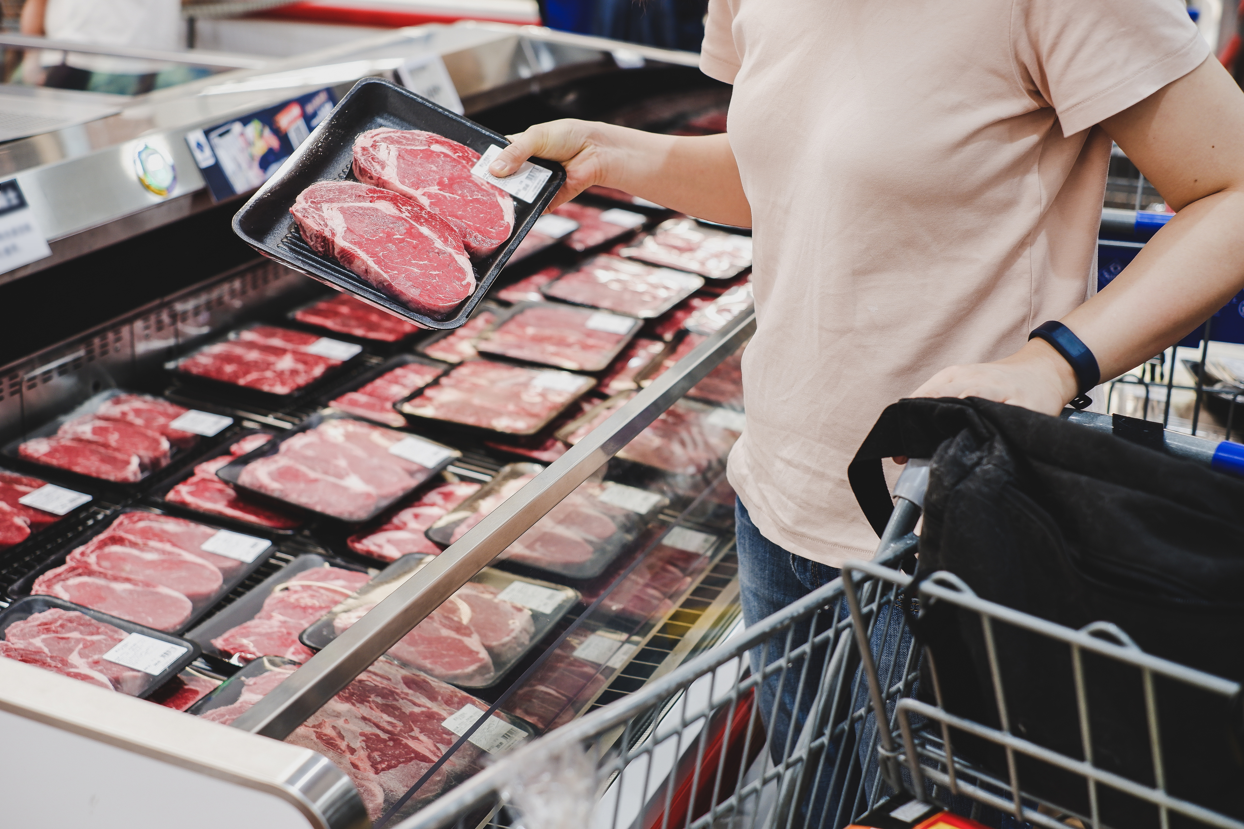 woman shopping for meat at the supermarket