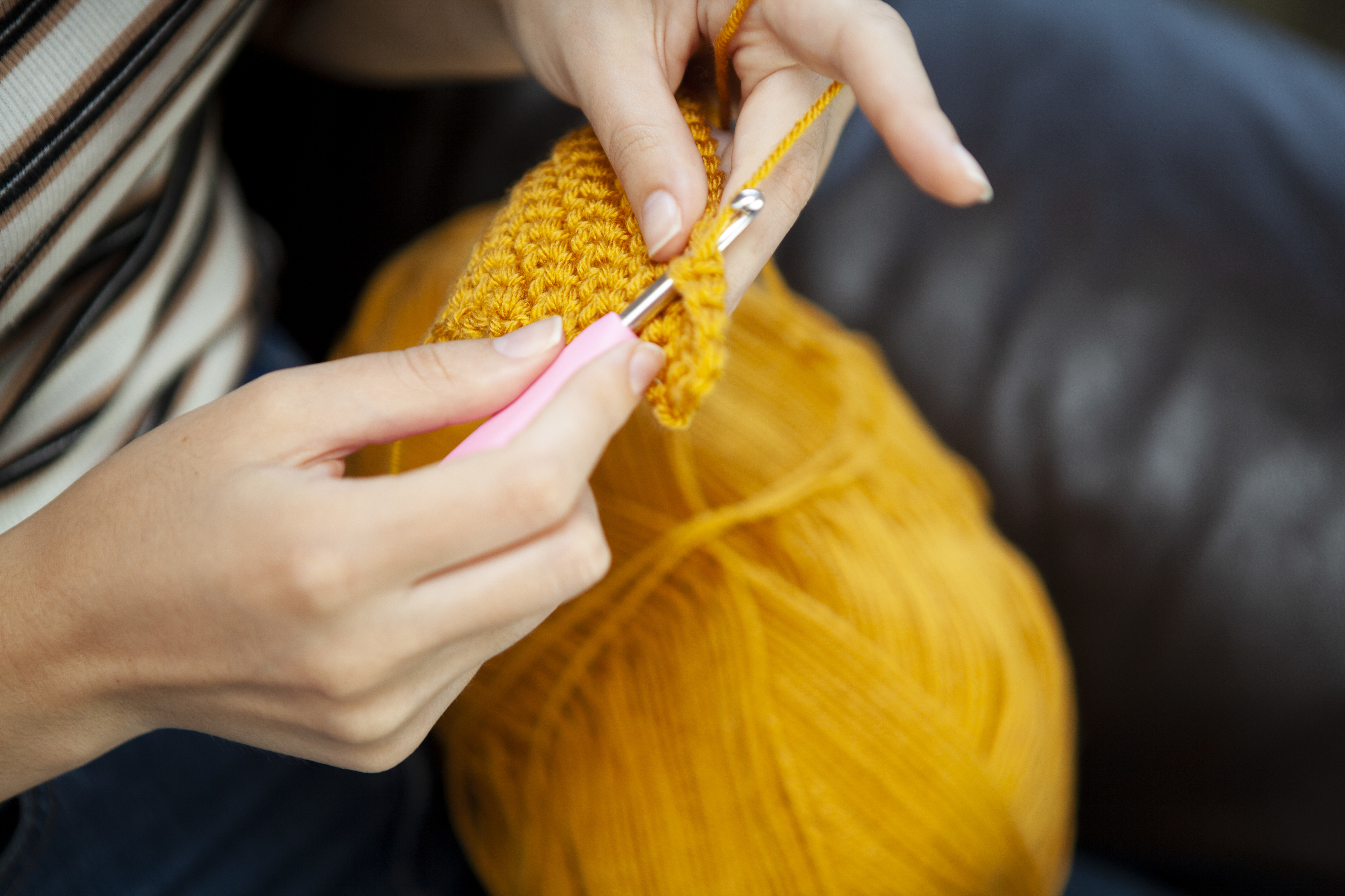 woman crocheting a gift