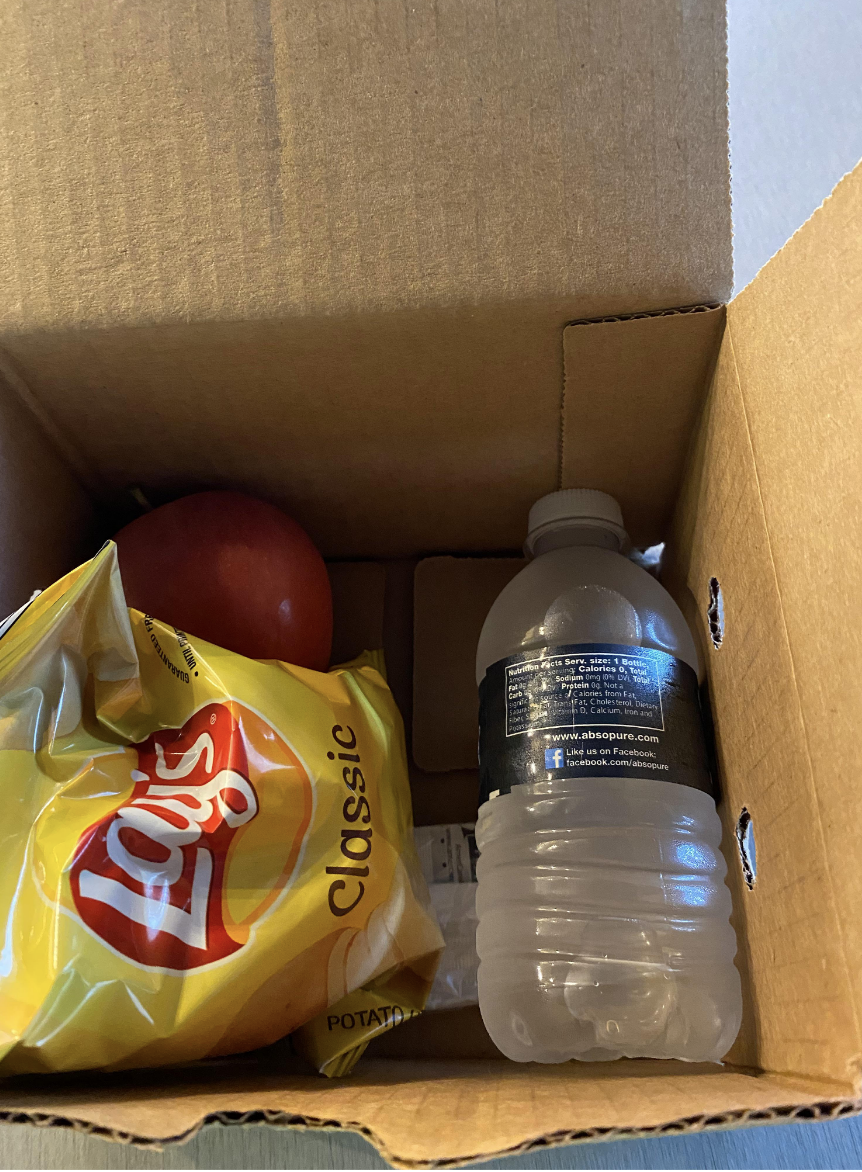 Lays, an apple, and a bottle of water in a box