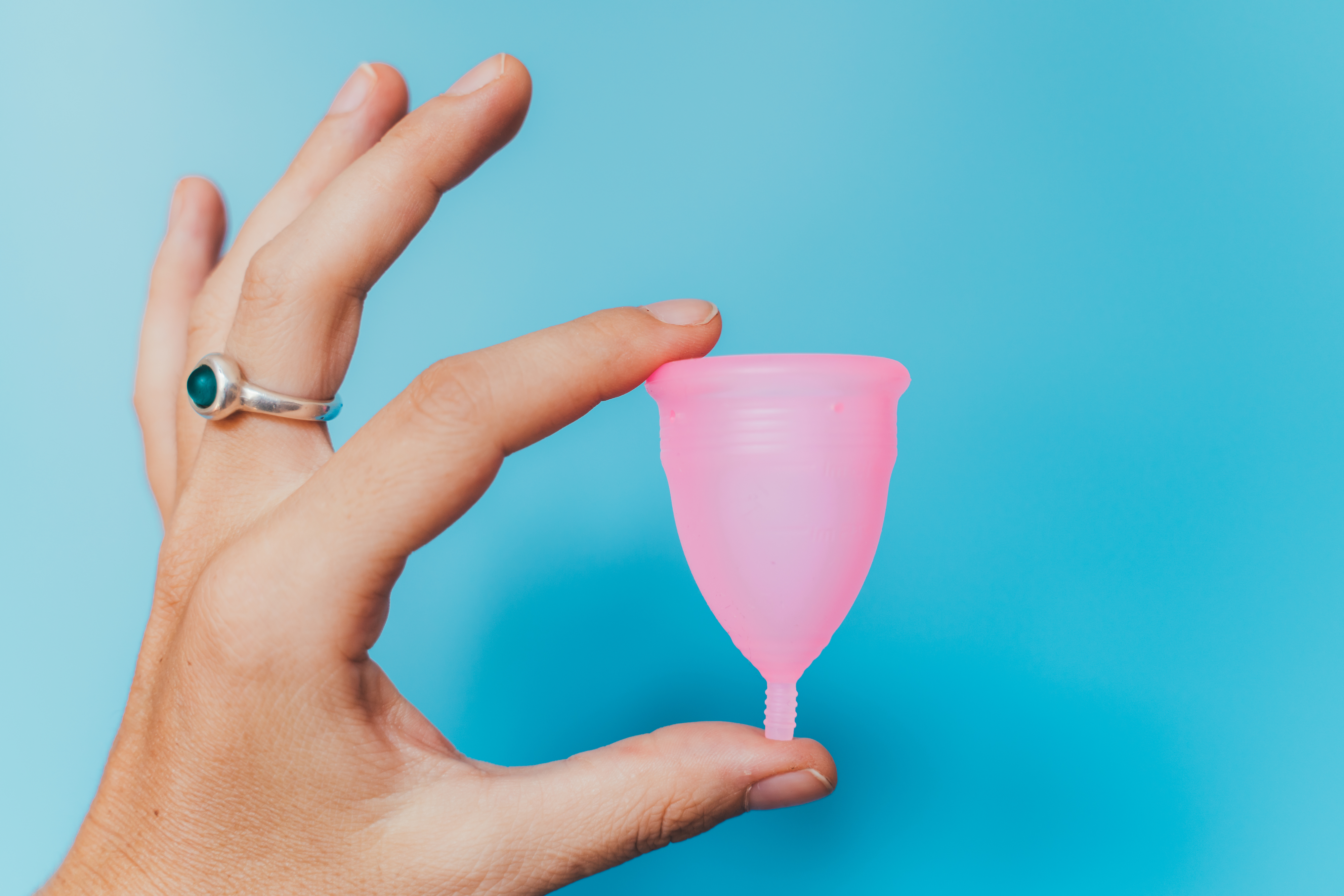 woman holding a menstrual cup
