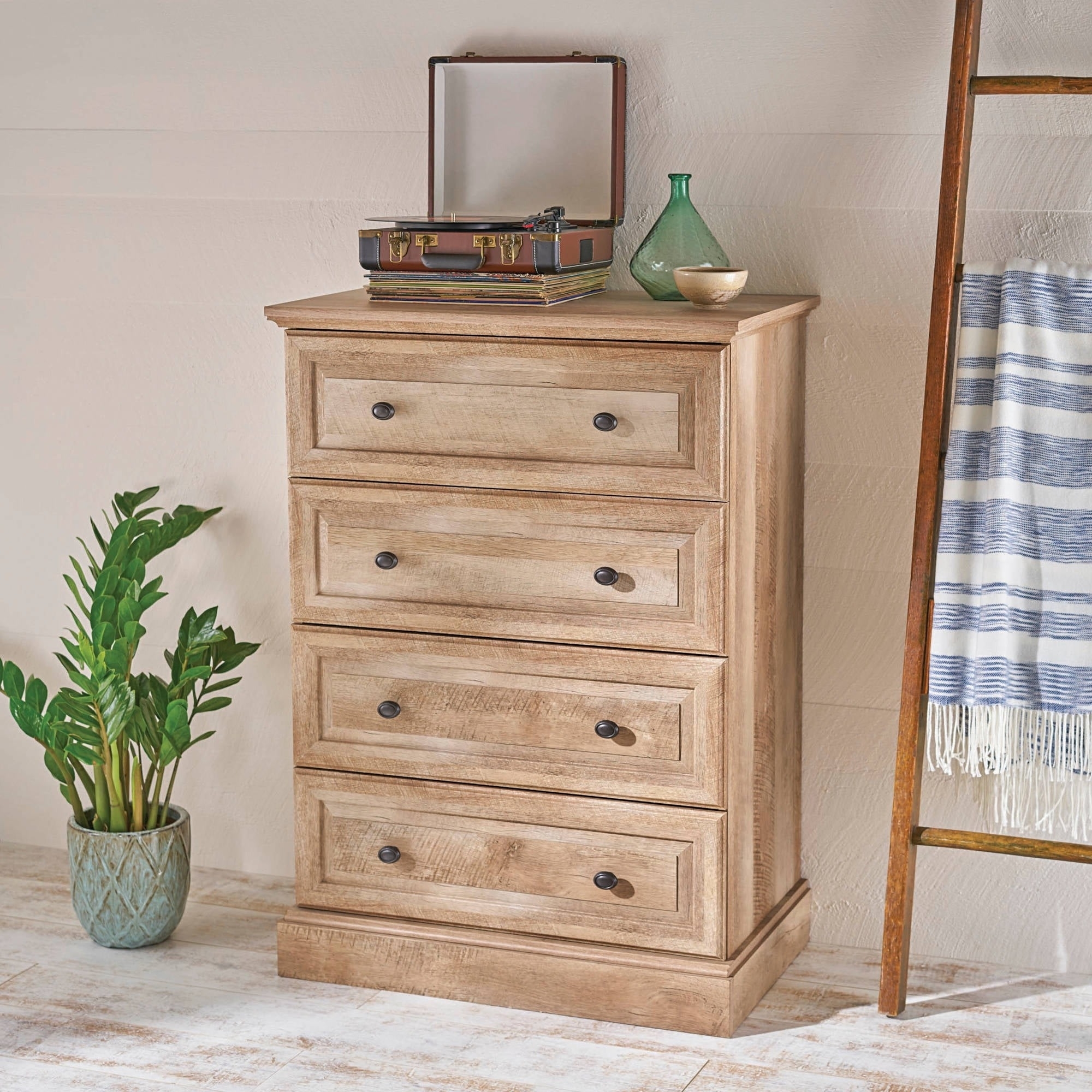 the dresser with four drawers in a bedroom