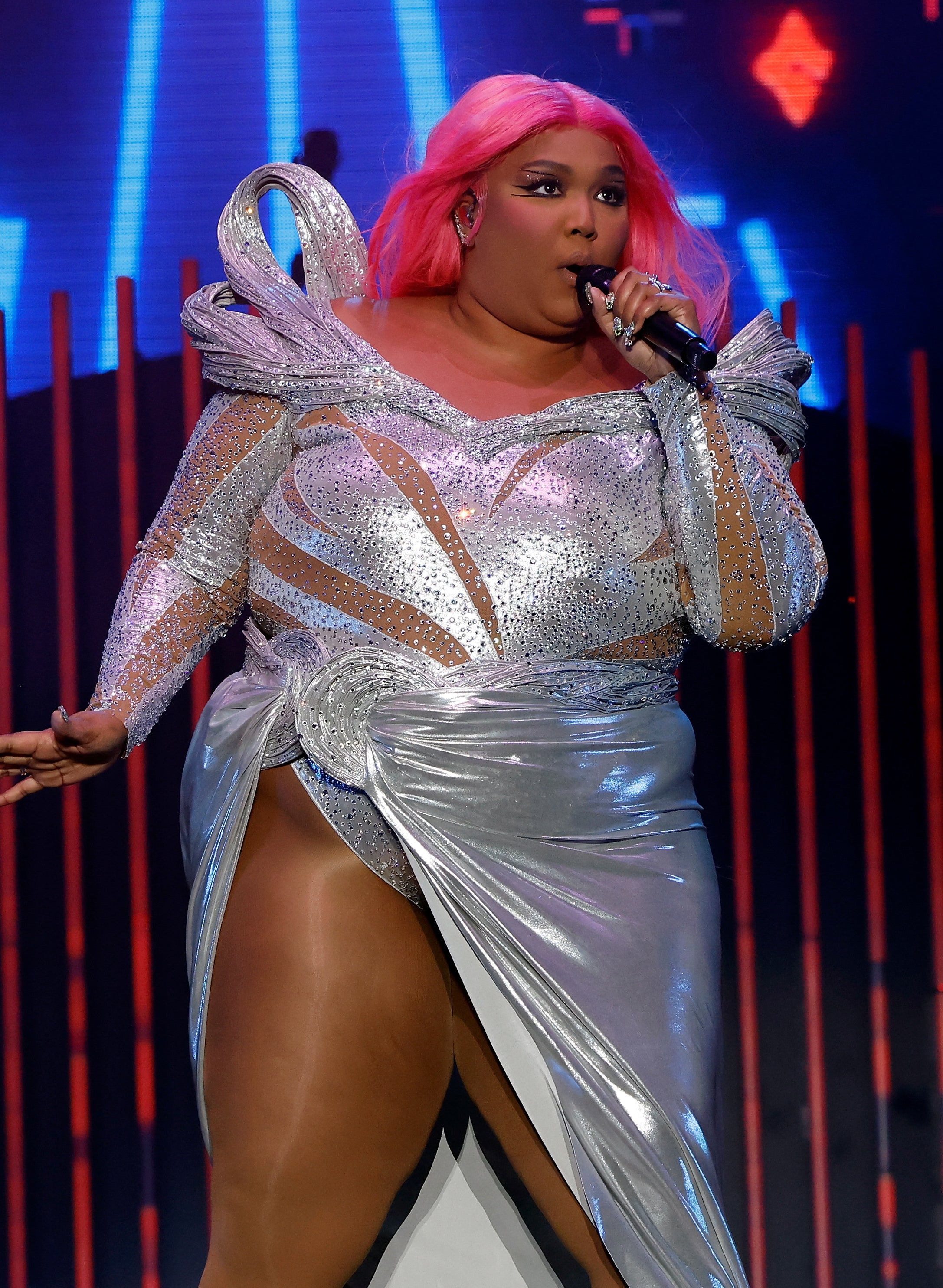 Close-up of Lizzo performing in a bejeweled leotard with a metallic skirt