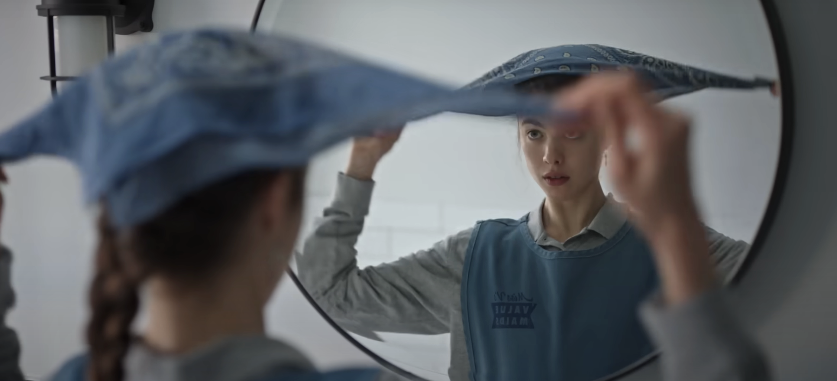 Close-up of a housekeeper in a TV show looking in a mirror