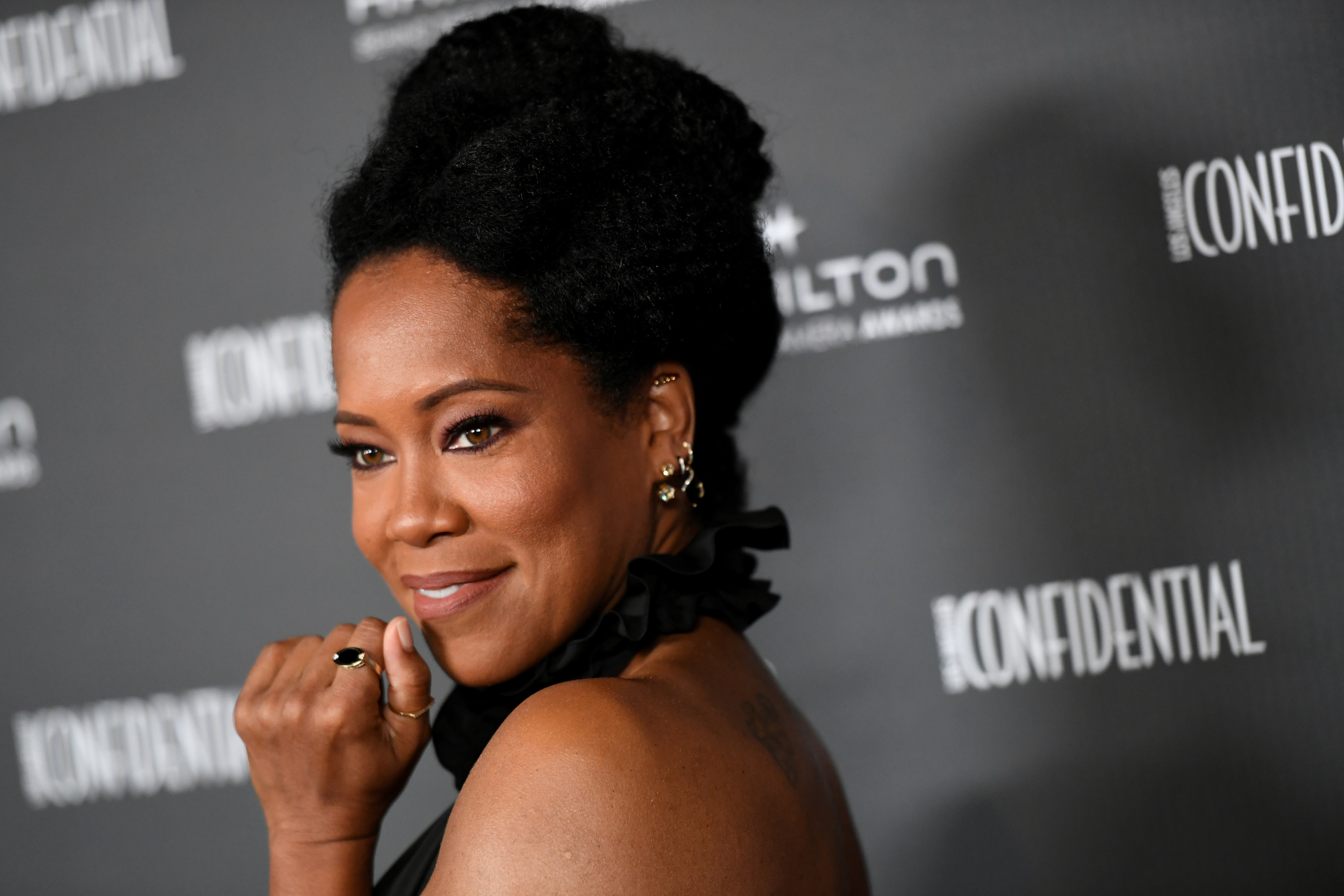 A close-up of Regina King posing for photographers on the red carpet at a media event