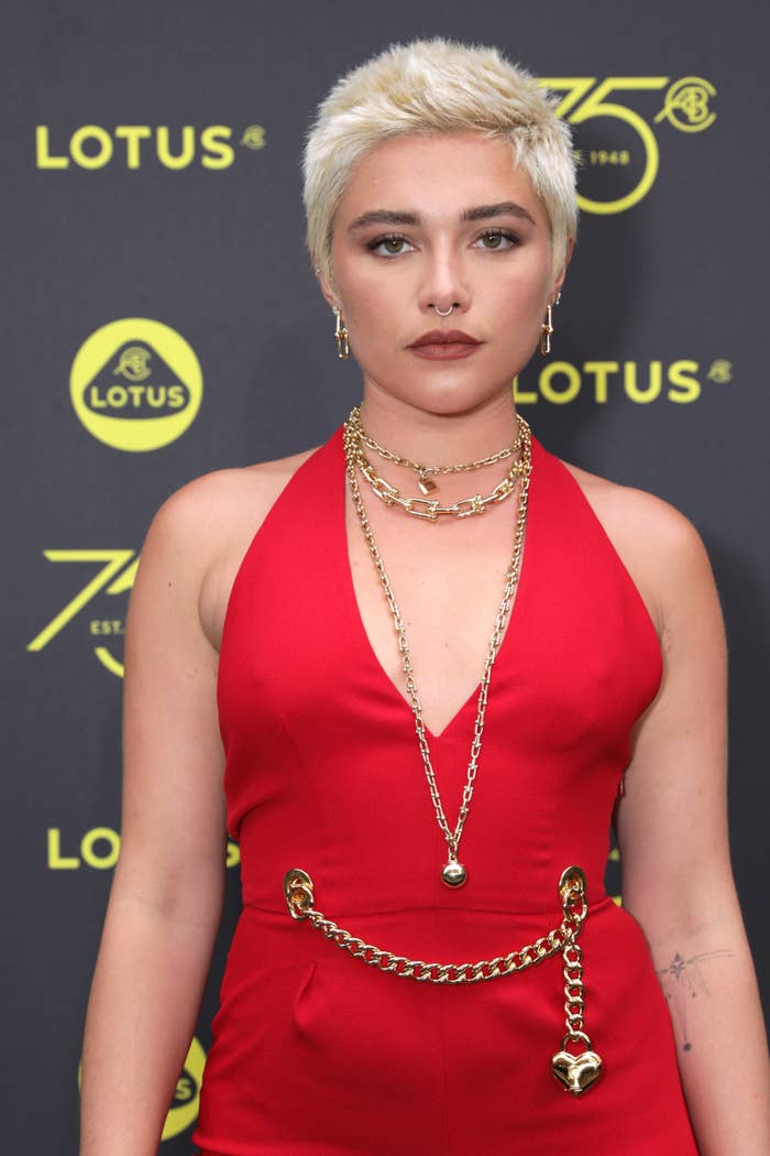 Florence Pugh on the red carpets in a halter outfit with chain detailing at the waist