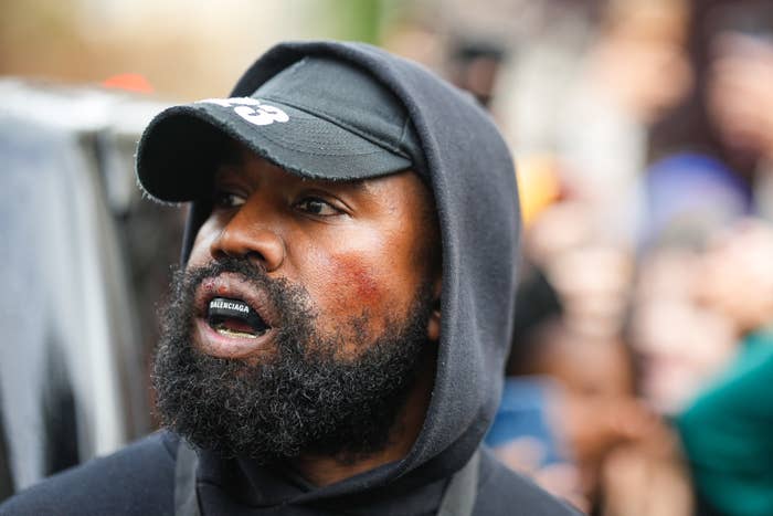 Kanye West wearing a Balenciaga mouth guard outside outside Givenchy, during Paris Fashion Week in October 2022