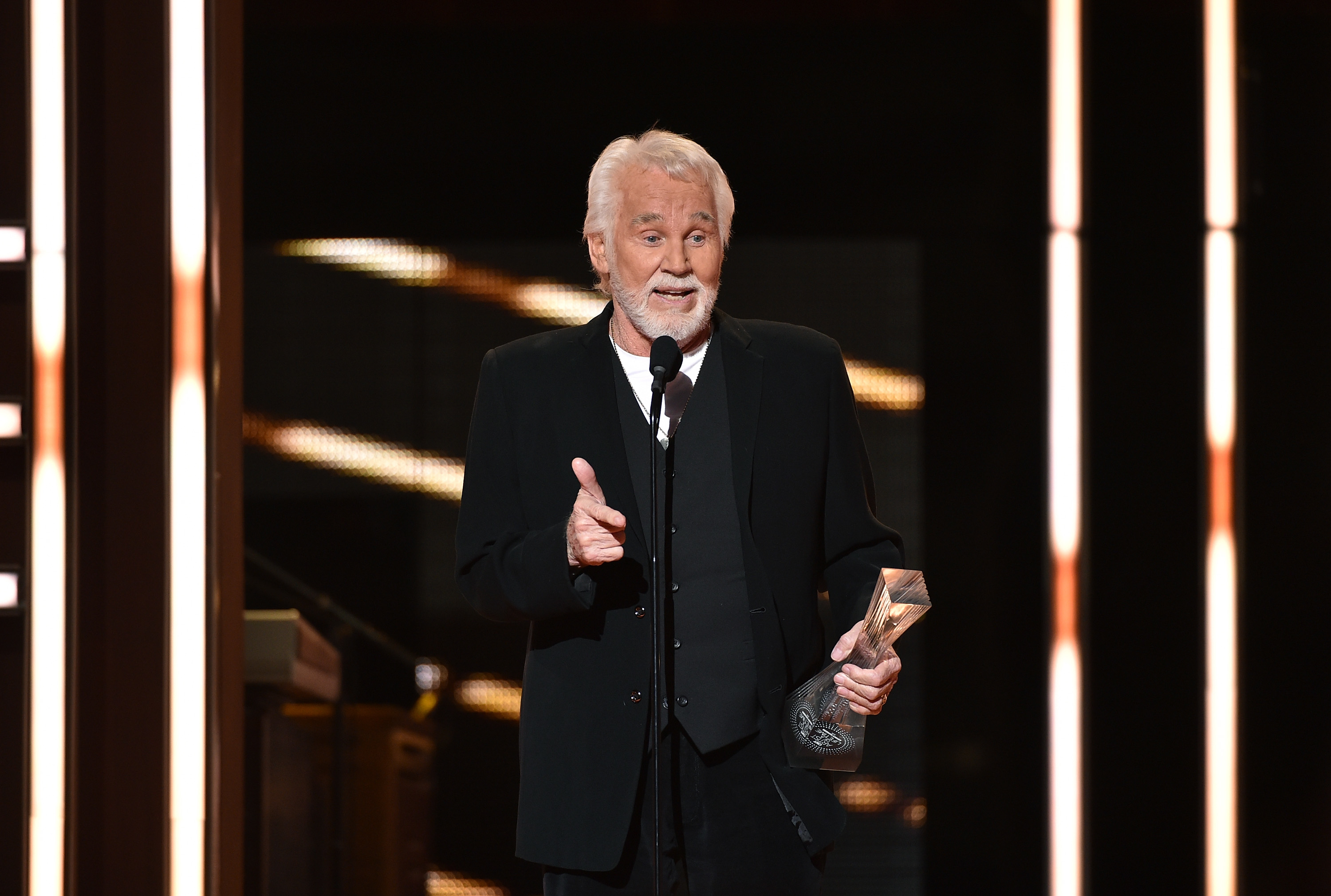 Kenny Rogers onstage accepting an award