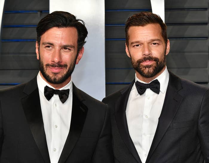 Jwan Yosef, on the left, stands next to Ricky Martin on the red carpet. They are both wearing tuxedos