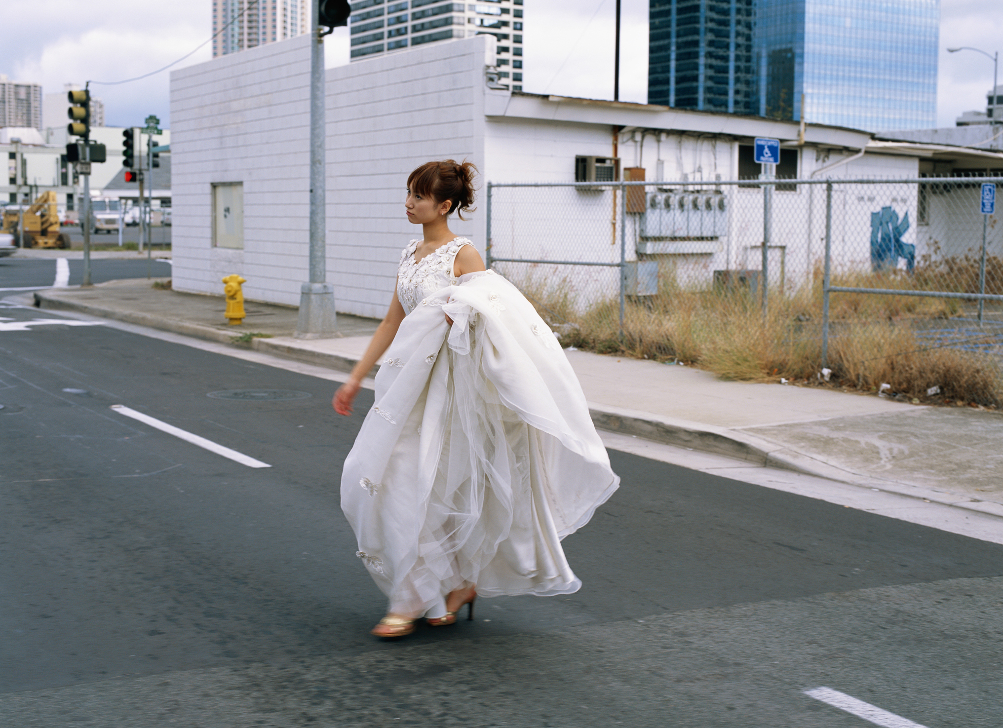 bride in her dress in the middle of the street