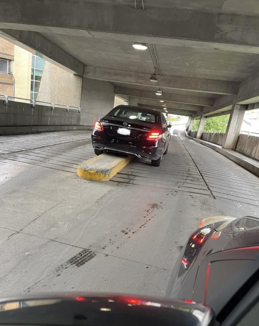 A car that&#x27;s straddling the barrier between both sides of the road