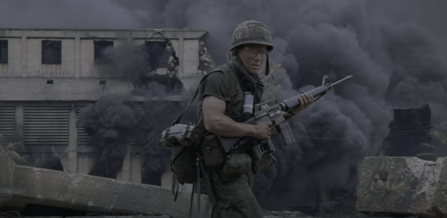 a soldier walks through ruins