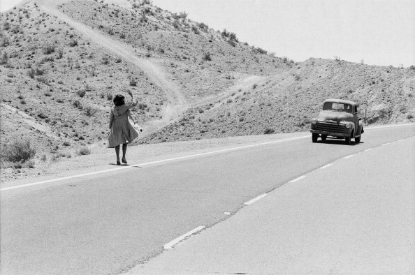 a woman hitchhiking
