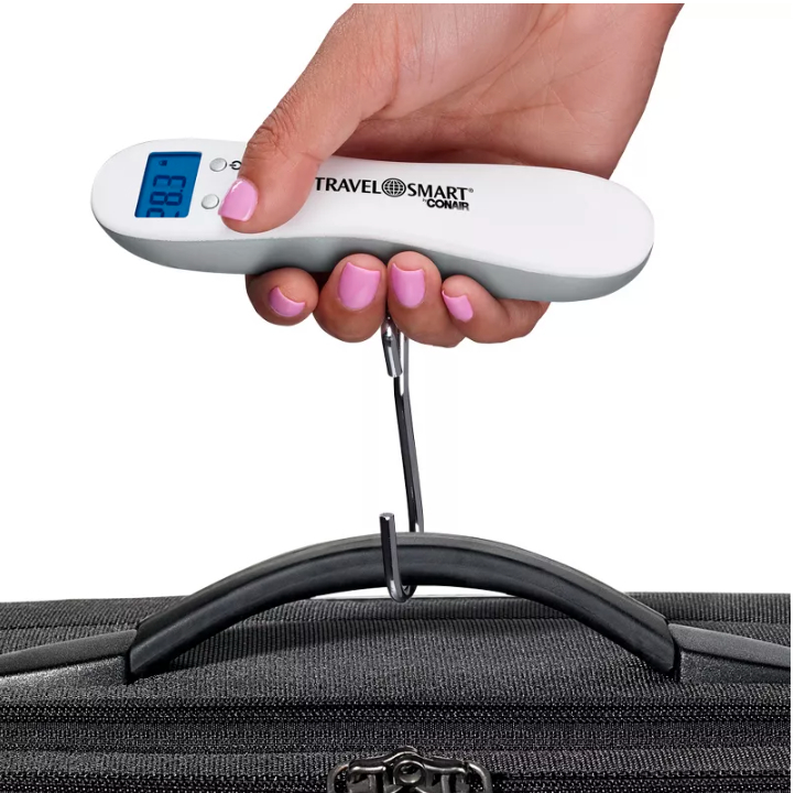 a hand using the digital luggage scale, hooked around a luggage handle